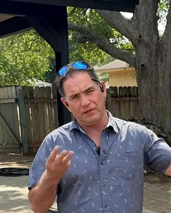 Tom McKay explaining a renovation on the patio of a flip house