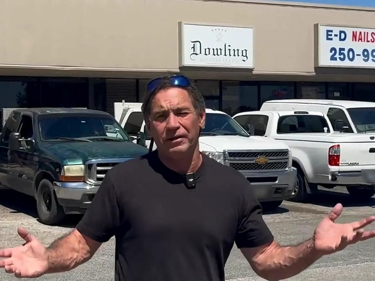 Tom McKay talking in the parking lot of his retail strip center